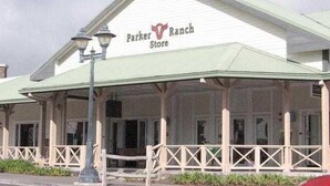 A Parker Ranch Store with a white facade and green roof, featuring a covered porch area. - Charming Waimea home on the Big Island- Close To Town!  (Waimea)
