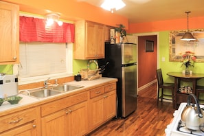 Enjoy cooking in this fully equipped kitchen with a sink, refrigerator, and dining area.