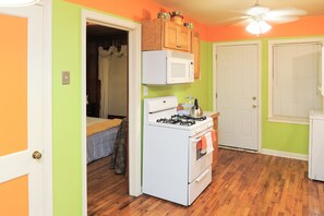 Enjoy cooking in this kitchen with a gas stove, microwave, and wooden cabinets.