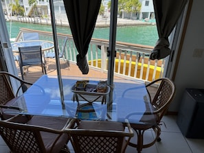 Enjoy a meal on the balcony with a view of the water and surrounding landscape.