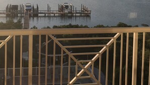 A view of a lake with a dock and a boat.