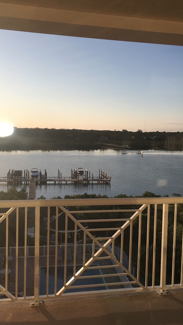 A view of a lake with a dock and a boat.
