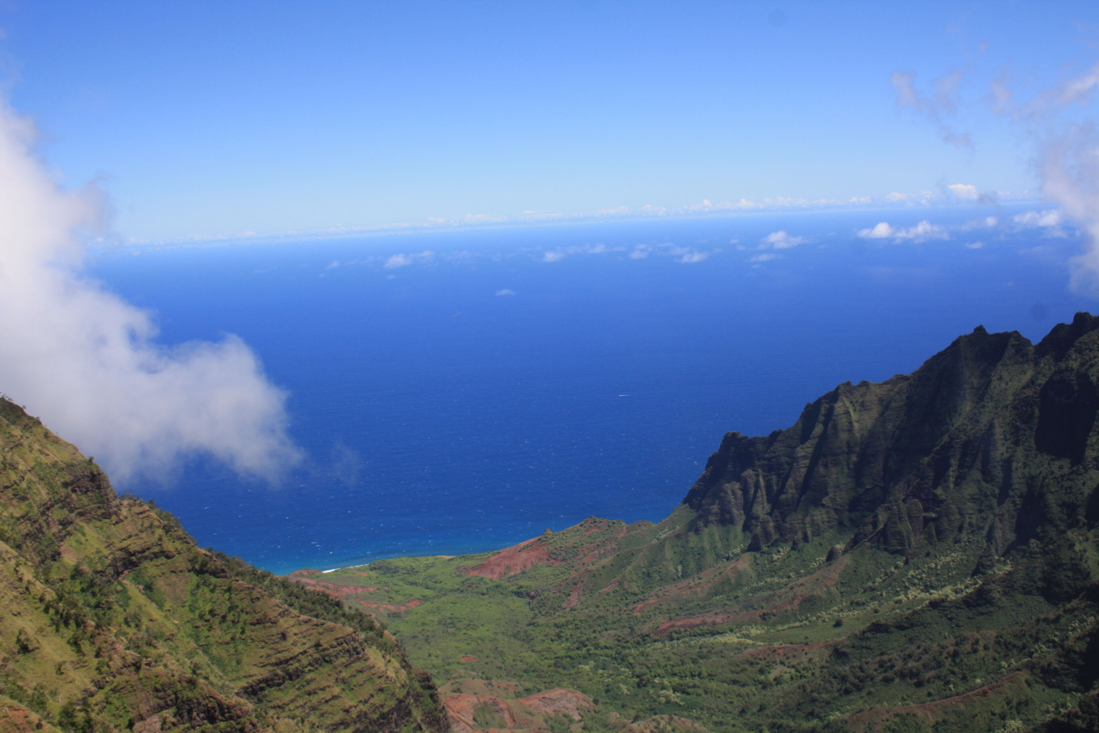 A mountainous landscape with a view of the ocean.