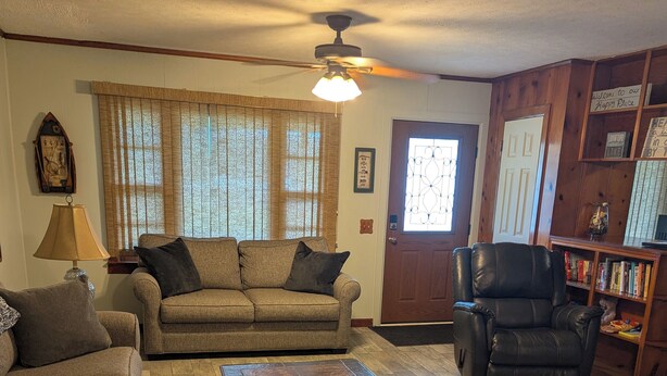 A living room with a sofa, armchair, and coffee table.