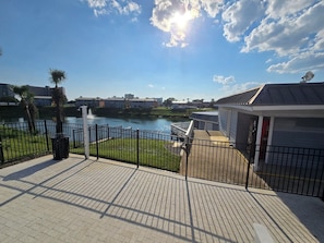 Guests can enjoy a serene view of the calm body of water from this peaceful outdoor space.