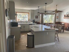 Enjoy meals in the well-lit kitchen with a central island and sink.