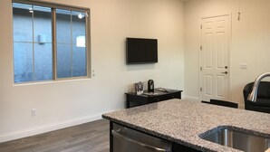 A modern kitchen with granite countertops, a stainless steel dishwasher, and a built-in oven. - Private One Bedroom Furnished Unit in Rancho Vistoso Eagles Summit Subdivision (Oro Valley)