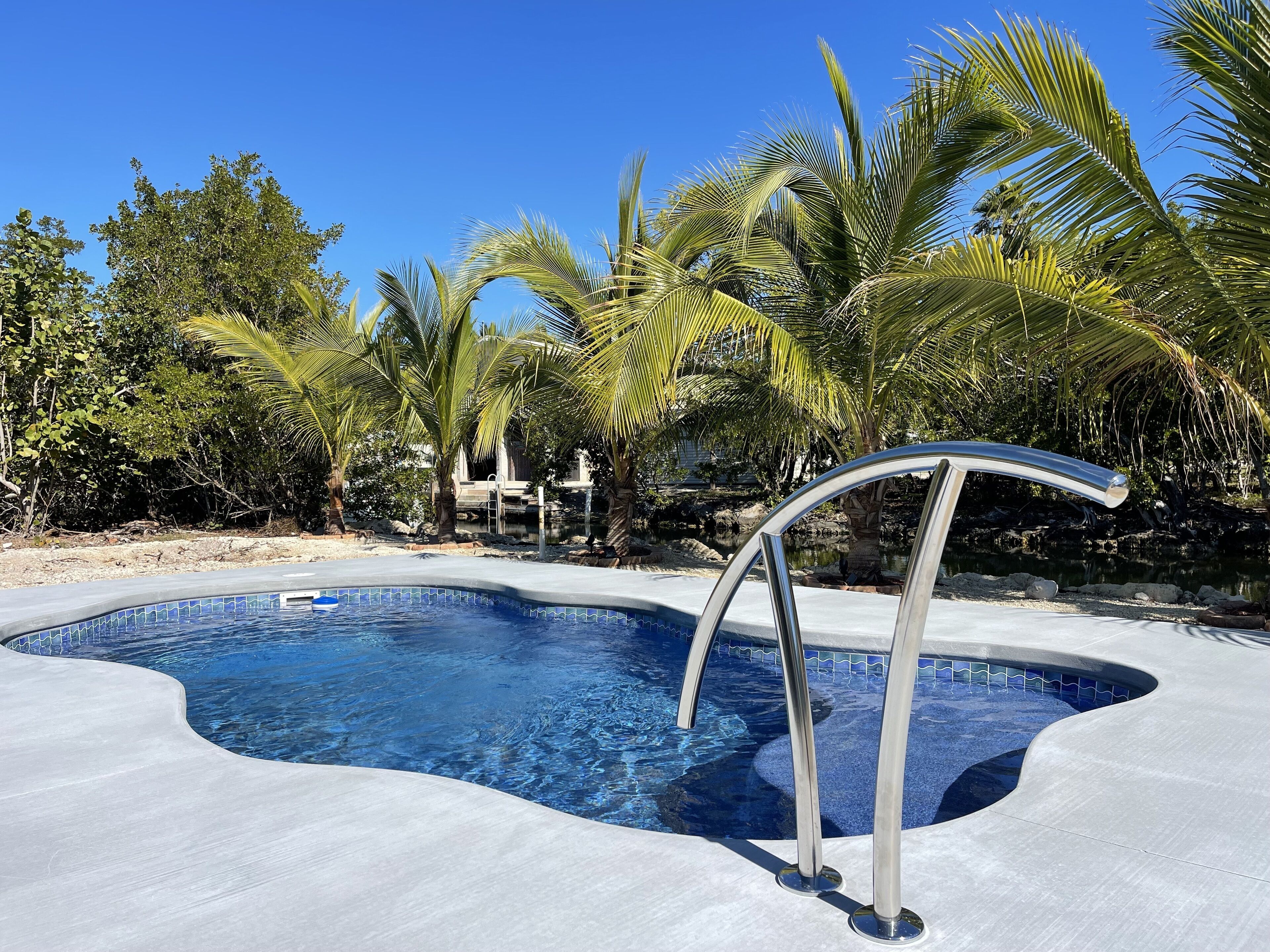 Doctors Arm waterfront with pool and Tiki hut. Ocean and backcountry