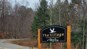 A sign for 'The Village of Loon Mountain' with a mountain silhouette. - White Mountain Four Season Vacation Getaway!! (Lincoln)