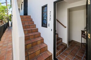 A staircase with red tiles leading to a door marked with the number 732. - Jersey Court Jubilee! Dual Town Homes on 1 Lot! (San Diego)