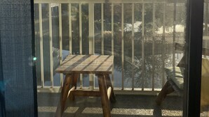 A balcony with a wooden table and a view of the sea. - The B.E.A.C.H.H.- STR Permit Number for this property is:
034944 (Hilton Head Island)