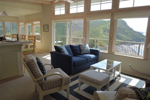 Living room overlooking the beach, ocean and mountain range