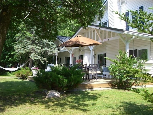 View of the cottage from the lake-side yard. Large deck for enjoying the sunset