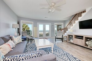 Relax in this inviting living area with a large sofa, coffee table, and flat-screen TV.