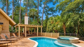 A pool area with lounge chairs, a covered seating area, and a hot tub. - 6 Piping Plover-A true smart home with media room! 146 Yard walk to the Beach (Hilton Head Island)