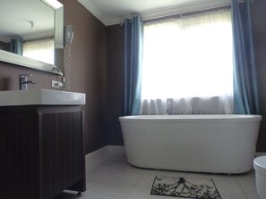 Bathtub, hair dryer, towels, soap