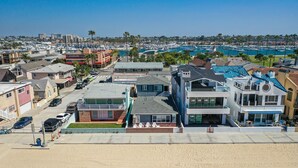 A coastal residential area with houses, a marina, and a beach. - BEACHFRONT GETAWAY ON THE SAND (Newport Beach)