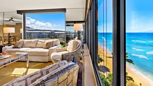 Un balcon avec vue sur l’océan et, au loin, un bâtiment d’hôtel.