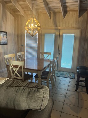 Enjoy meals in this cozy dining area with a wooden table and comfortable chairs.