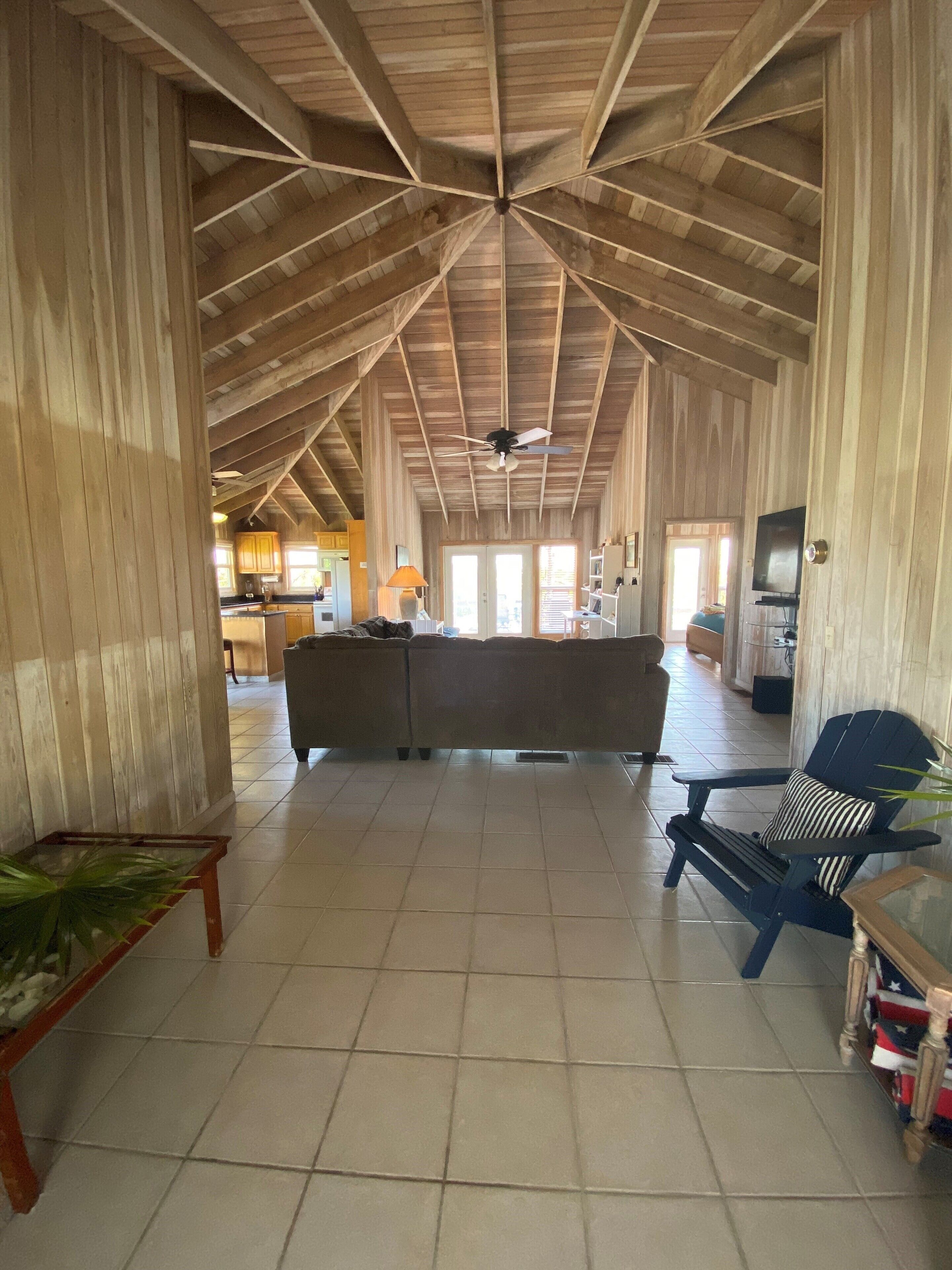 Front entry, with vaulted ceiling leading to living area.