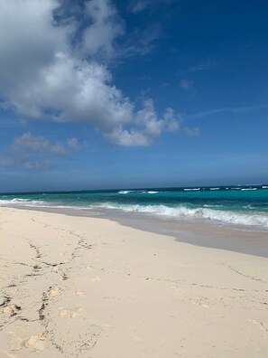 Enjoy a serene beach experience with gentle ocean waves and soft sand.