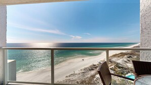 A balcony with a view of a beach and ocean. - Beachside II 4338 - modern beachfront condo with pool, resort tram + balcony (Miramar Beach)