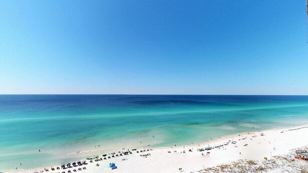 A beach with clear turquoise waters and a sandy shore. - Beachside II 4338 - modern beachfront condo with pool, resort tram + balcony (Miramar Beach)