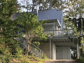 A two-story building with a metal roof, a balcony with a railing, and a door. - Beautiful Mountain Home with Gorgeous View (Franklin)