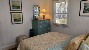 A bedroom with a bed, dresser, and two framed pictures on the wall. - Waterfront with Private Pier and Tranquil Water views! (Gloucester Courthouse)