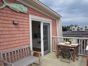 Relax in this serene outdoor space with a bench, table, and chairs, perfect for dining or unwinding.