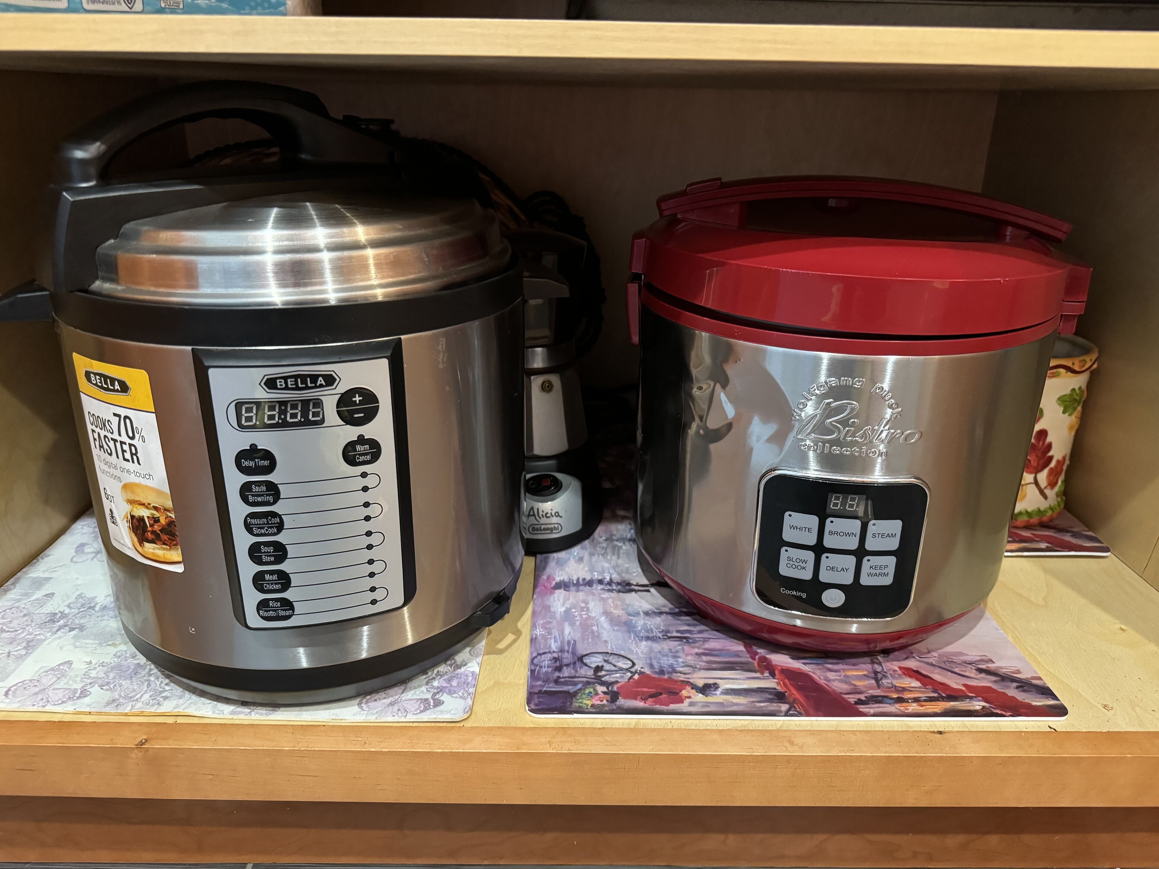 Two kitchen appliances, a pressure cooker and a slow cooker, on a shelf.