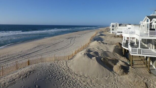 A beachfront property with a sandy beach, ocean view, and a white building with multiple balconies. - Quiet North Beach Oceanfront Steps to Private Beach  3 Night Min Stays Available (North Beach)
