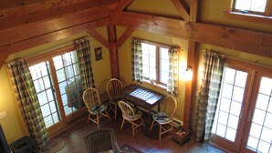 A cozy room with a wooden ceiling, a dining table with chairs, and large windows with curtains. - Tranquil And Peaceful Vacation Getaway Just Waiting To Welcome You (Bristol)