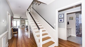 A staircase with white railings and wooden steps leading to a second floor. - Oceanfront Home, Stunning Views, Sun Deck, Screened Porch, Walk to restaurants! (Sullivan's Island)