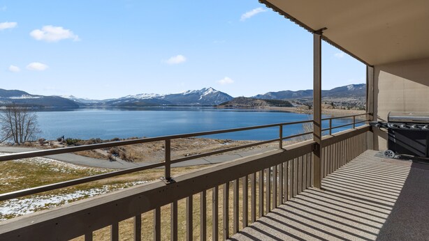 A balcony with a view of a lake and mountains. - Dillon Lake 2 BR Condo-Pool, Hot Tub, 4 lift passes at Keystone-Breck & Arapahoe (Dillon)