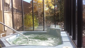 A hot tub with a view of a stone wall and trees. - Dillon Lake 2 BR Condo-Pool, Hot Tub, 4 lift passes at Keystone-Breck & Arapahoe (Dillon)