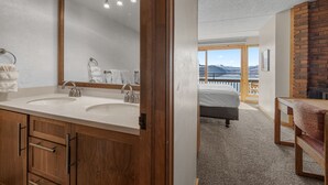 A bathroom with two sinks, a large mirror, and wooden cabinets. - Dillon Lake 2 BR Condo-Pool, Hot Tub, 4 lift passes at Keystone-Breck & Arapahoe (Dillon)