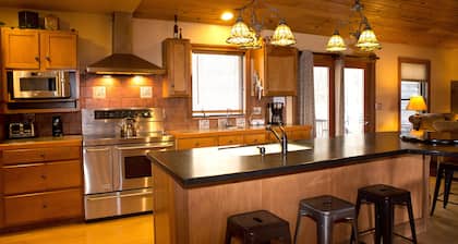 The Lodge at Harvest Moon sleeps 16 with five bedrooms and unique private Pub