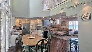 A spacious open-plan living area with a dining table, kitchen, and seating area.