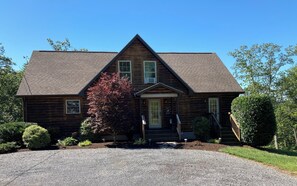 A two-story log cabin with a steeply pitched roof, a front porch, and a gravel driveway. - Dog Friendly Skyline Drive Retreat: 3 King Suites, Views & Firepit! 1pm checkout (Front Royal)
