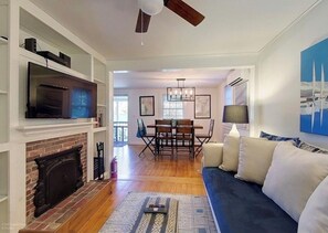 Cozy living room with a fireplace, television, and comfortable seating area.