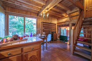 A wooden interior with a kitchen area, a dining table, and a staircase. - Chalet Vaffier, Argentière (Chamonix), France (Argentière (Chamonix))