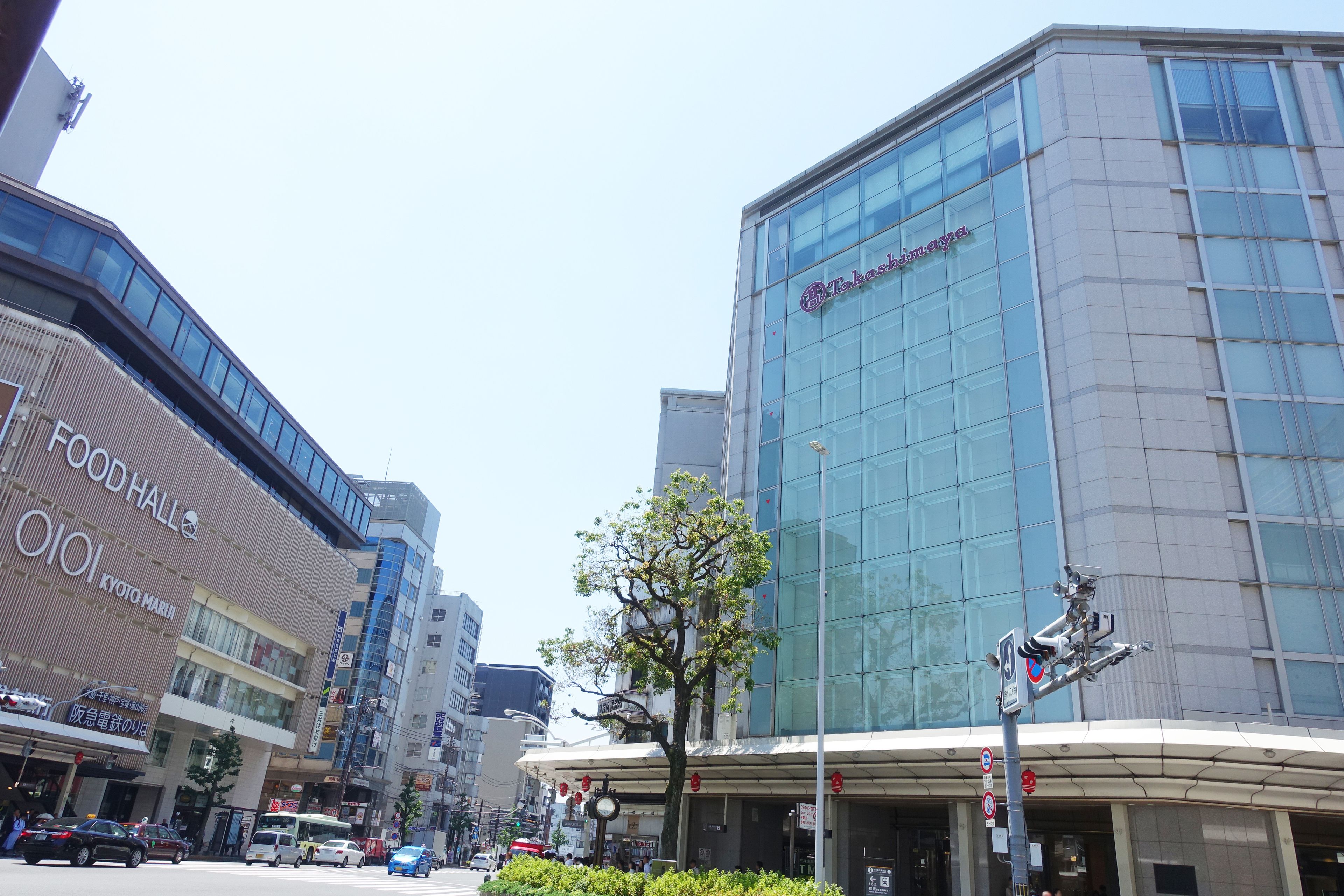 A modern building with a glass facade and signage for 'The Bank of Japan'.