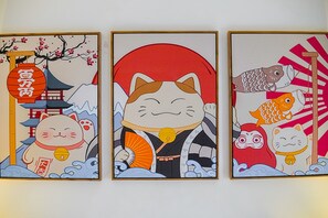 Three framed artworks depicting Japanese cat characters in various settings. - Yuanli Wafu Guesthouse (Shanghai)