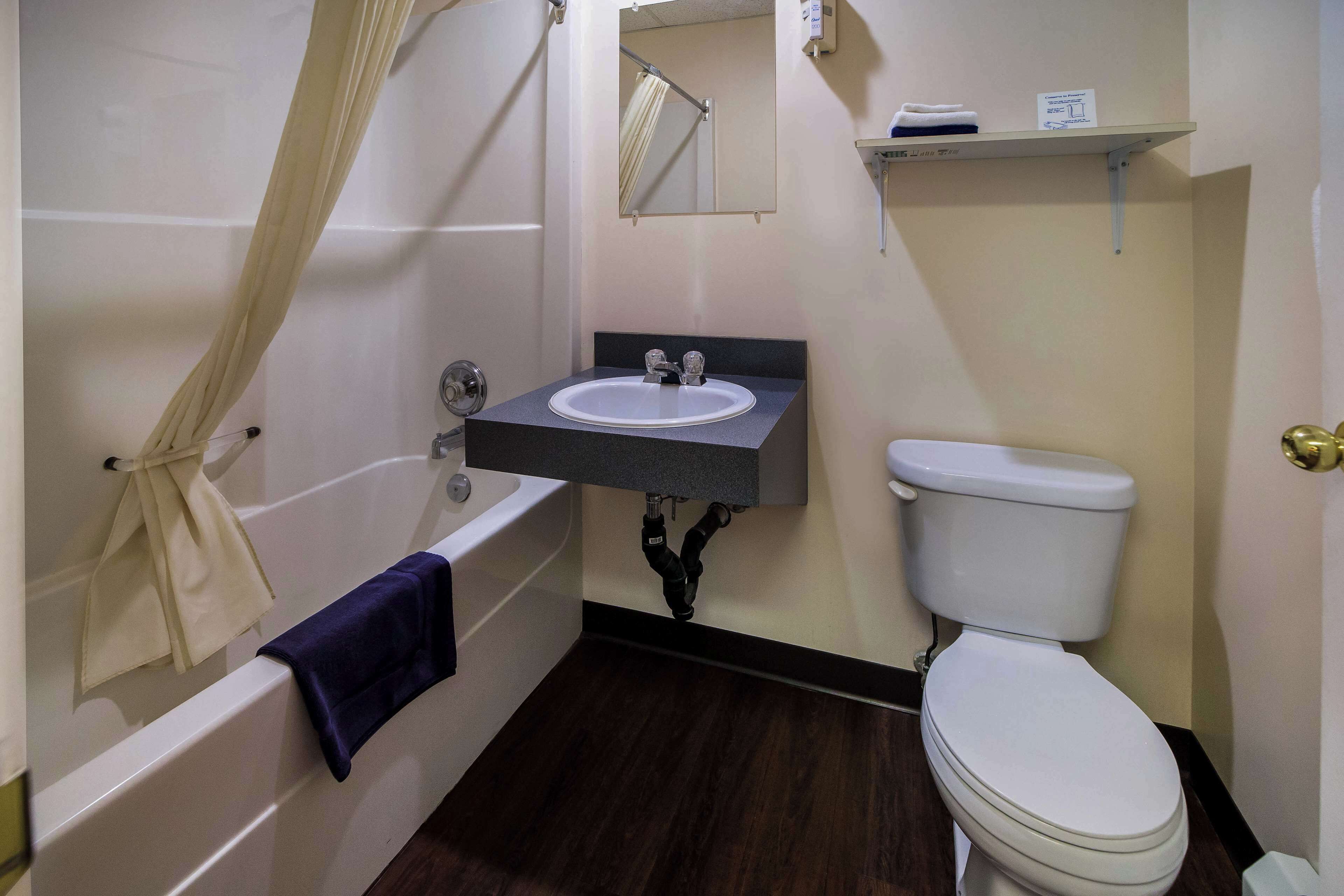 A bathroom with a bathtub, a sink, and a toilet.