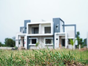 A modern two-story building with a flat roof and a symmetrical facade. - Malhaar Resort (Dahegam)