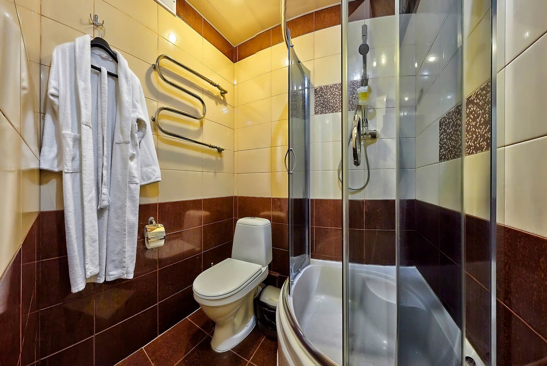 A bathroom with a glass-enclosed shower, a toilet, and a bathtub.