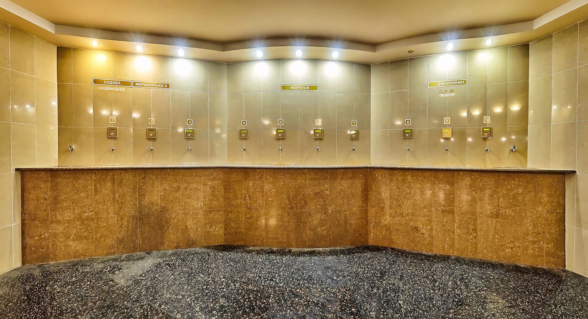 A hotel bathroom with multiple sinks, each marked with a number and a sign indicating the floor level.