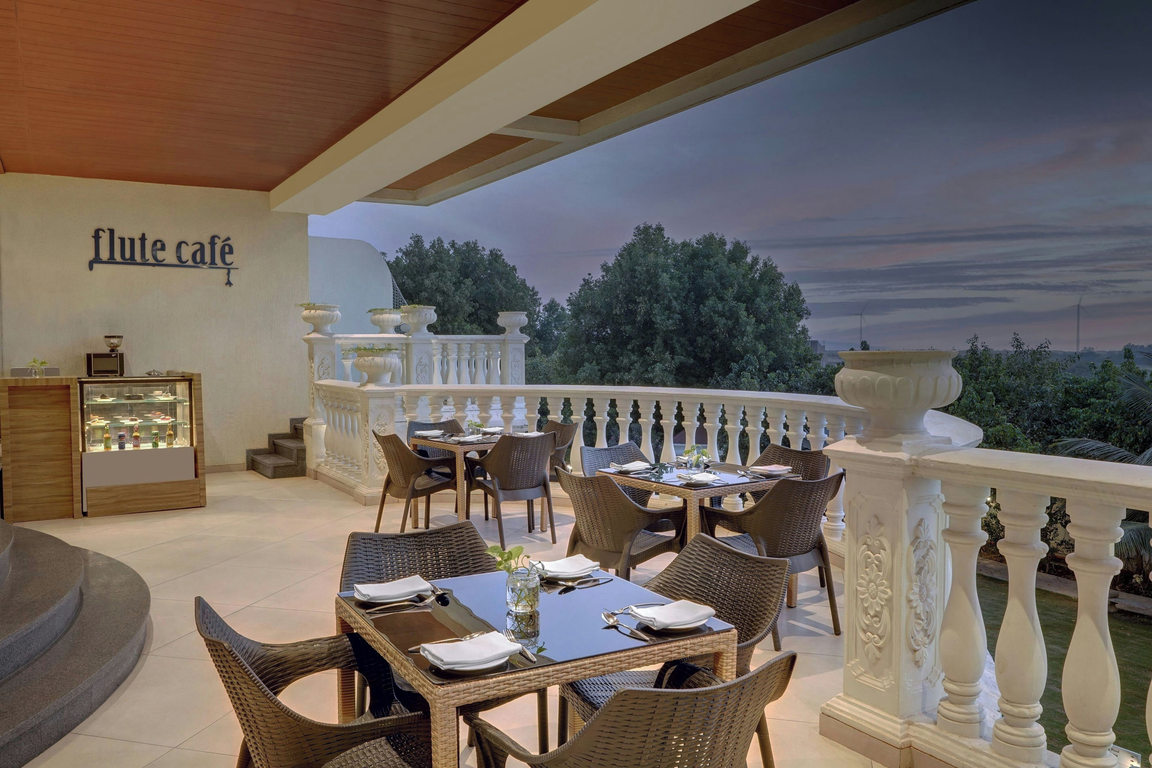 An outdoor seating area with wicker furniture and a view of the trees.