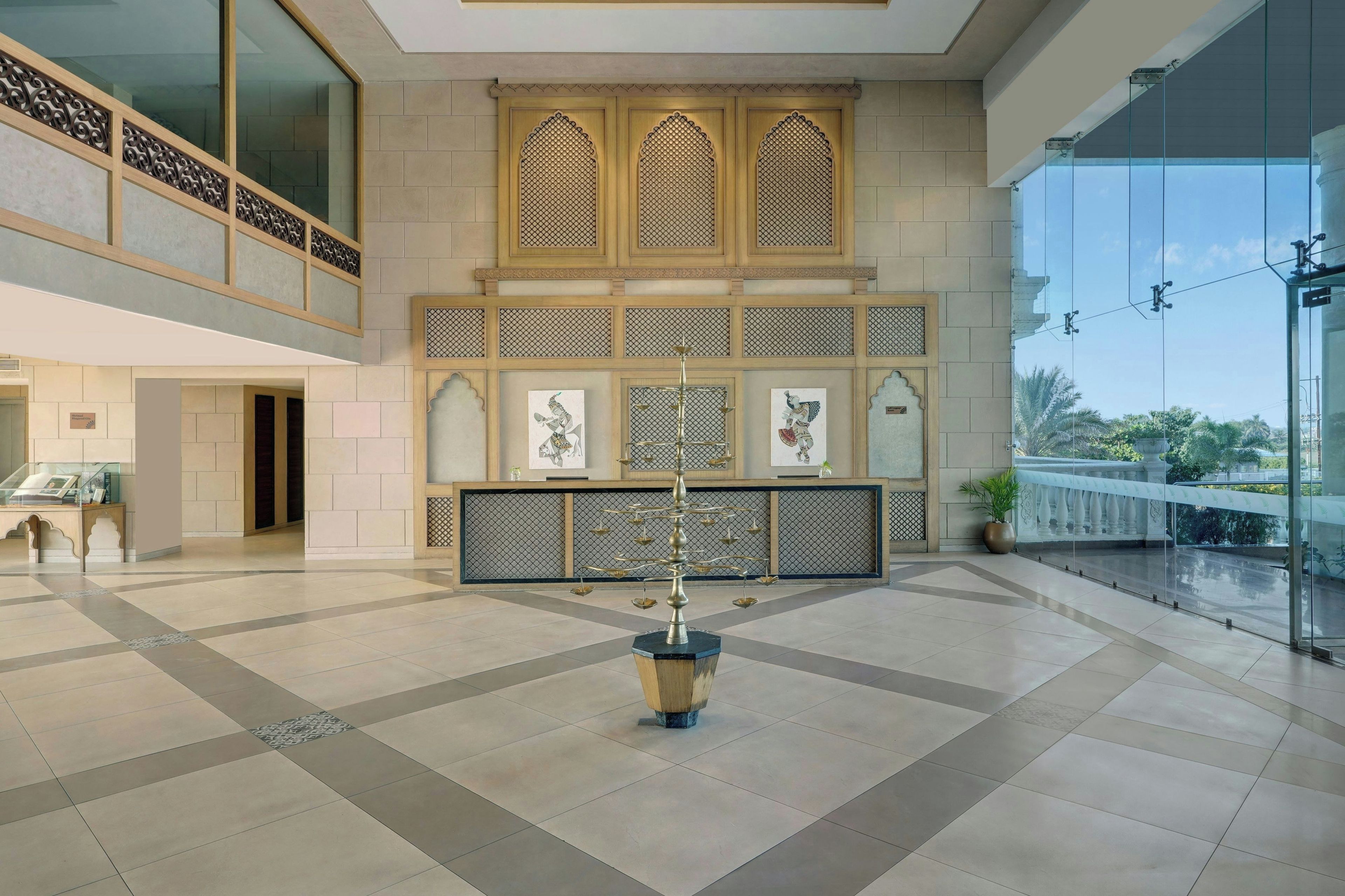 A spacious lobby with a checkered floor, a reception desk, and a decorative fountain.